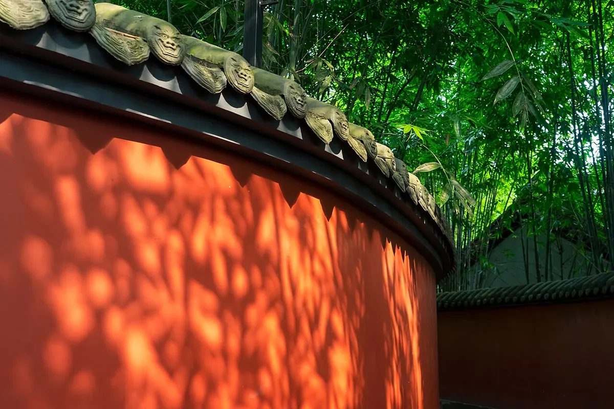 Bamboo shadows on the red wall of the Wuhou Shrine in the sunlight.