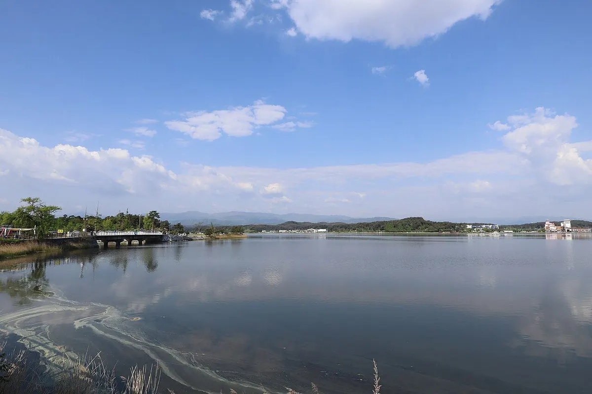 平静湖面倒映着蓝天白云的镜浦湖。