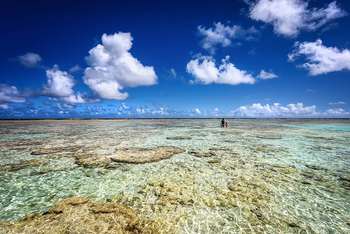 Ritidian Point's white-sand beach, blue sea and clouds