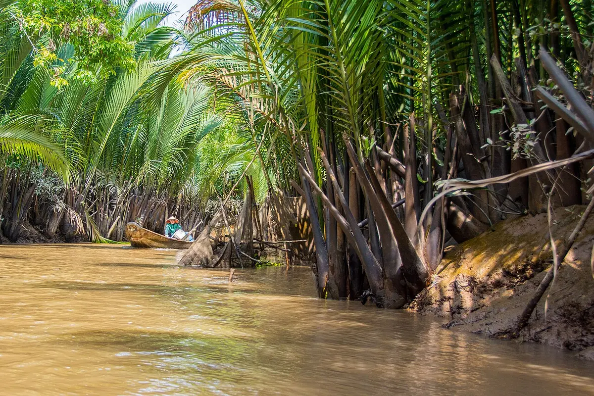A canal with boats in the Mekong Delta near My Tho