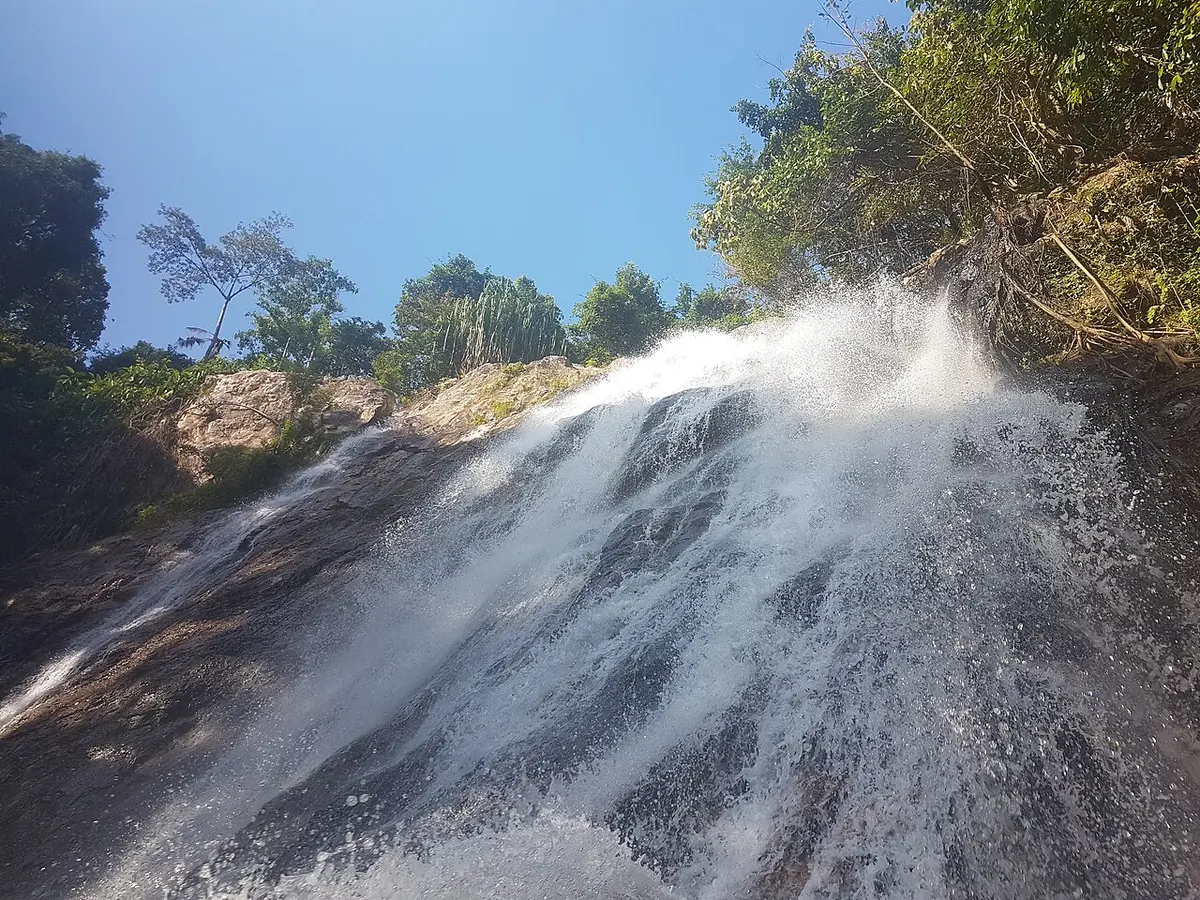 Na Muang waterfall cascading over rocks in the forest