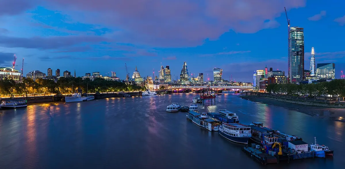 The City of London skyline and St Paul's Cathedral along the Thames at dusk