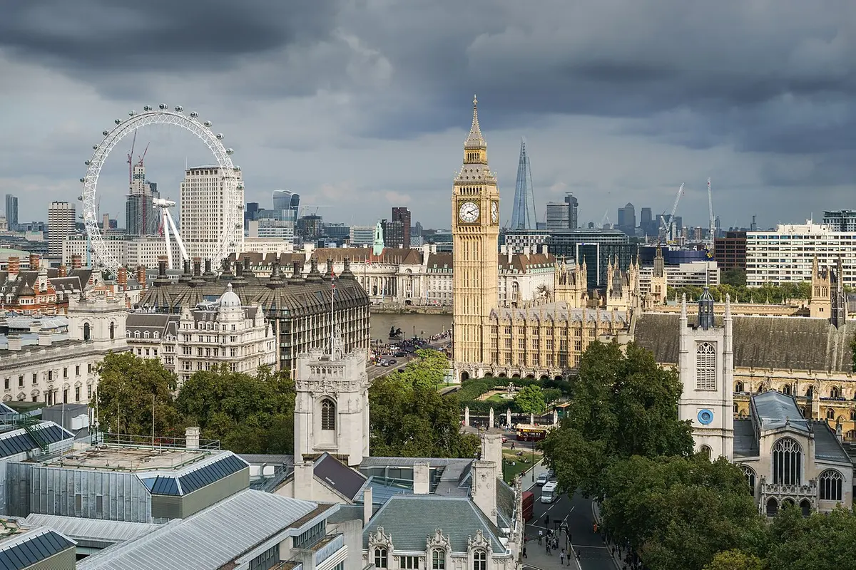 The Houses of Parliament and Big Ben seen from above, with the London Eye in the distance on the left