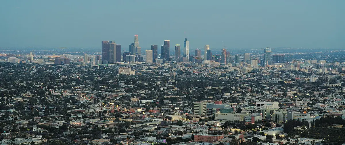 Downtown LA's towers and the sprawling city seen from the hills at dusk