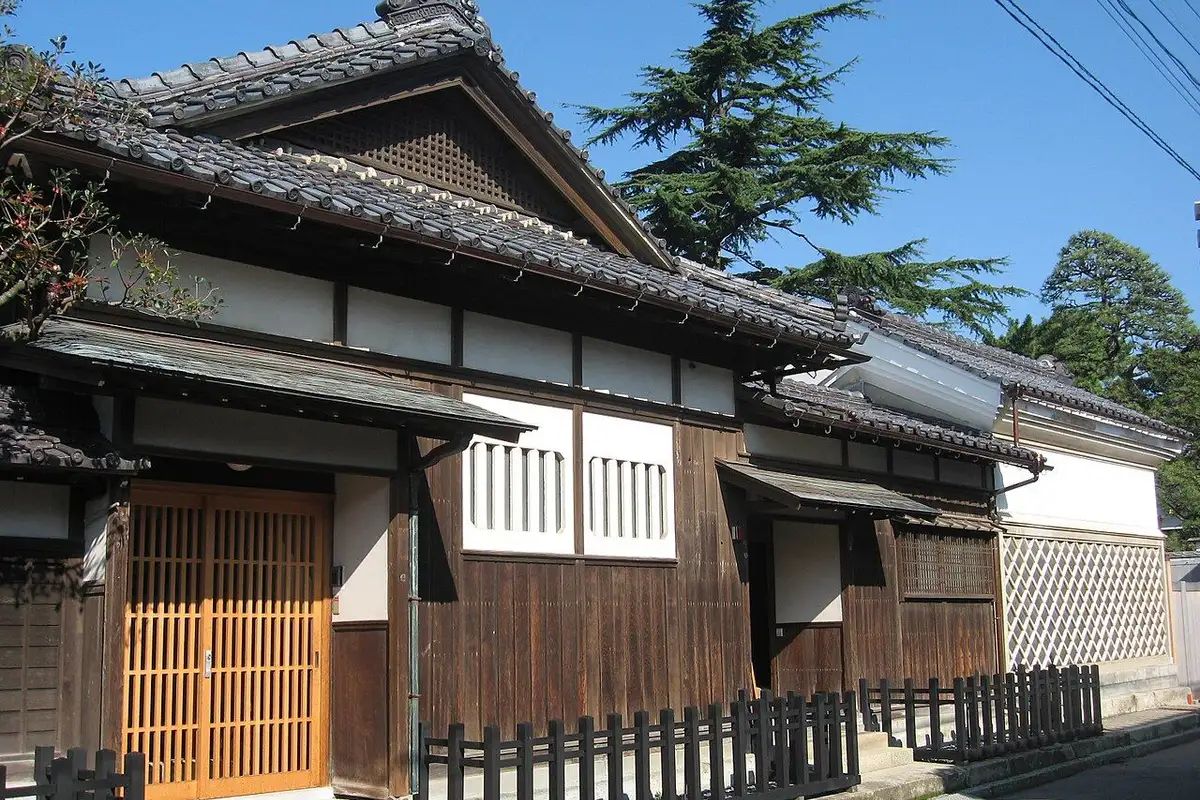 瓦屋根と木の格子戸が並ぶ旧齋藤家別邸の入口付近の建物。