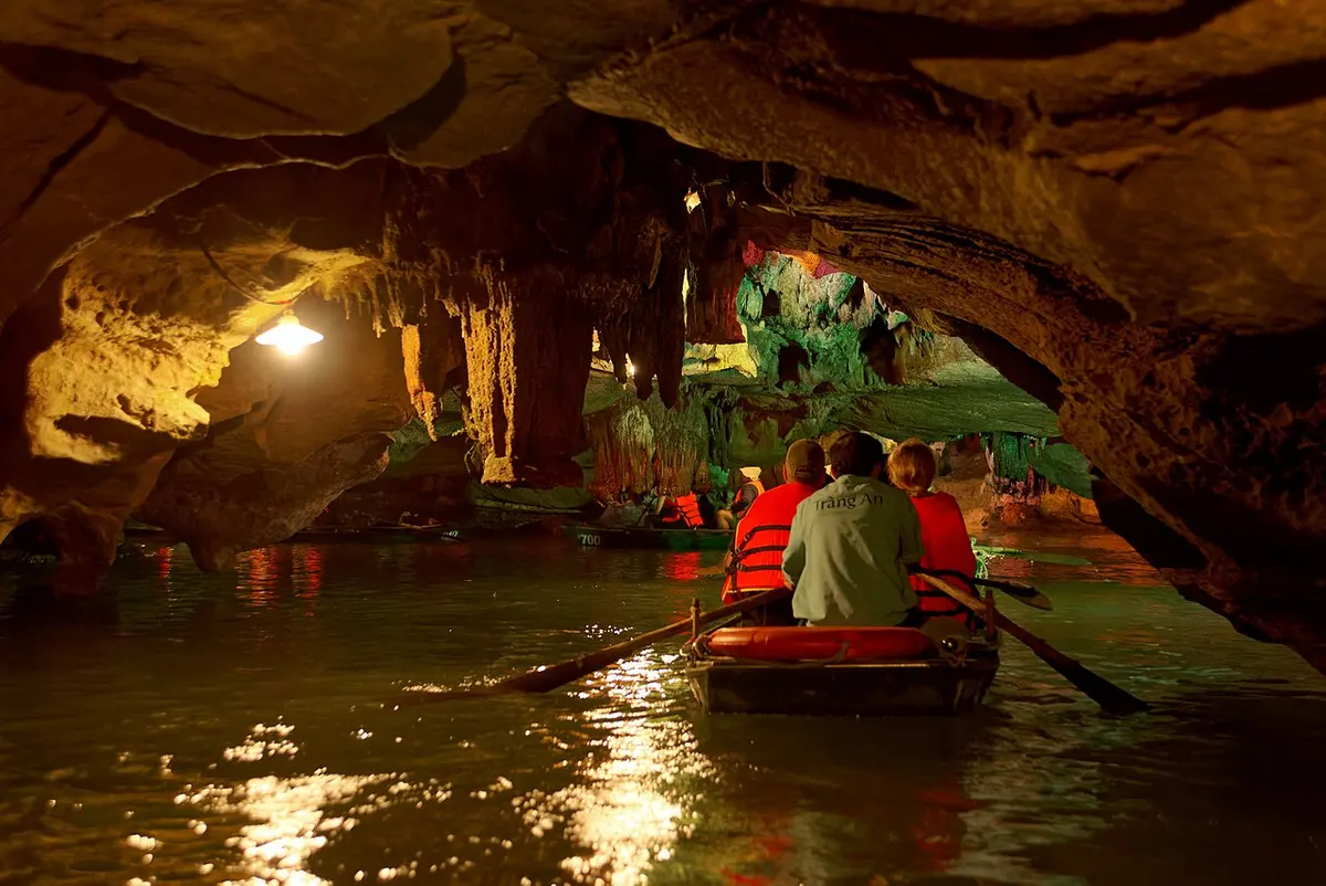 Limestone peaks, waterways and tour boats at Trang An