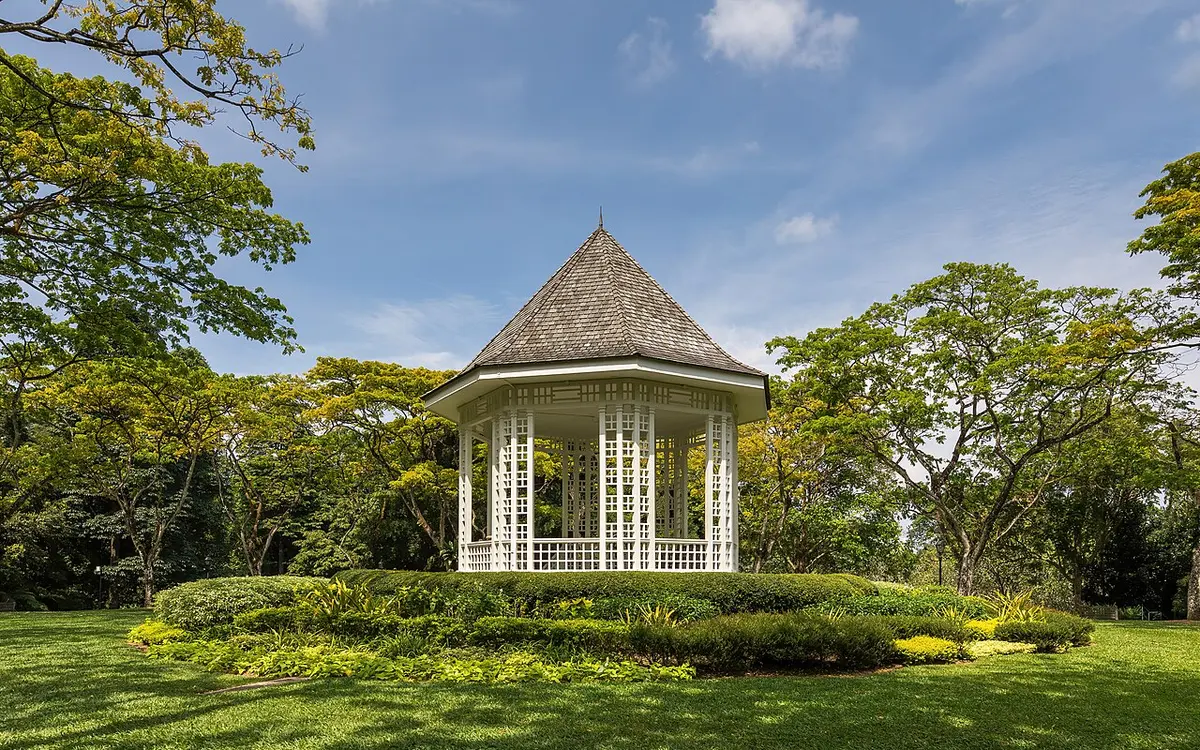 The bandstand and green trees at Singapore Botanic Gardens on a sunny afternoon