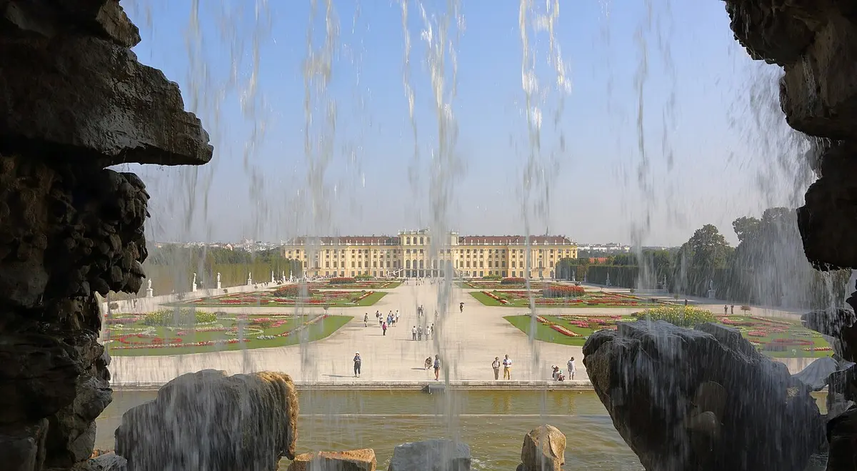 Schönbrunn Palace and gardens seen through the Neptune Fountain