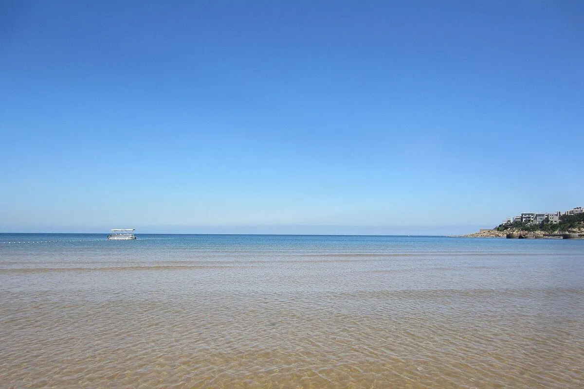 Shallow, calm summer sea under a clear sky at Weihai.