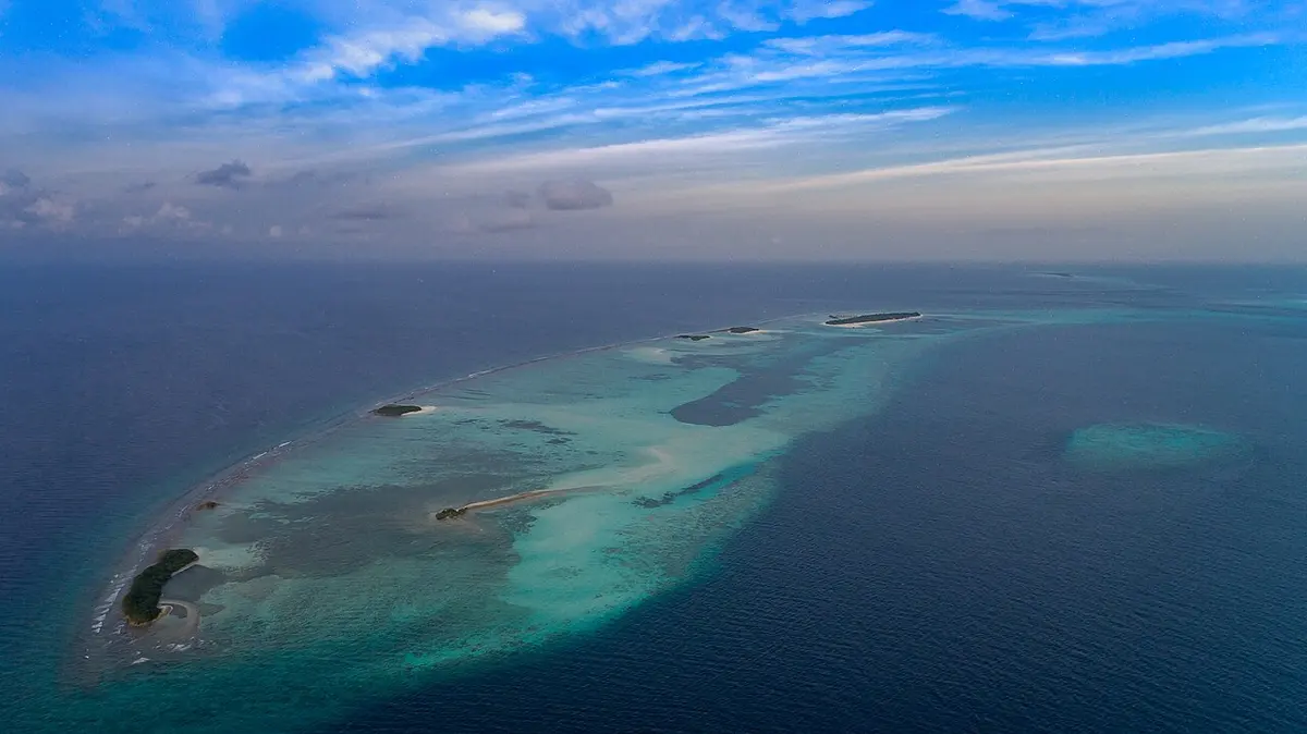 Aerial view of islands and shallow lagoons in a Maldives atoll